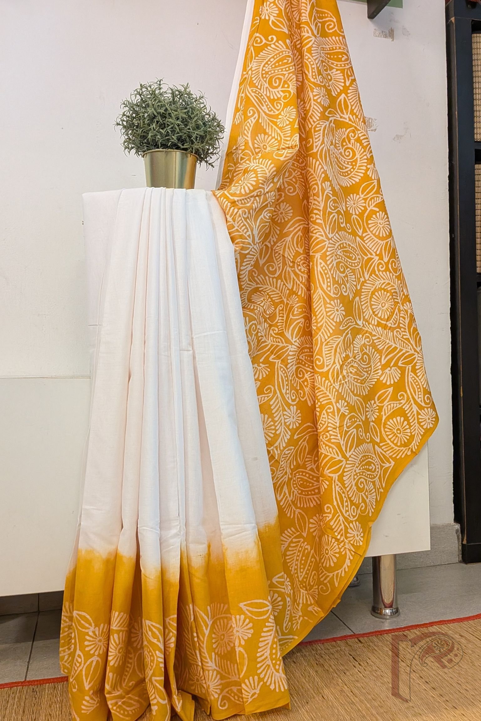 Mulmul Muse – White and Orange Hand Batik Mulmul Saree with Creeper Motifs