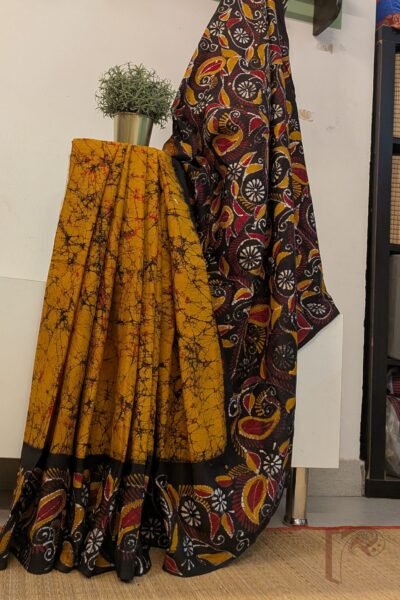 Mulmul Muse – Orange and Black Hand Batik Mulmul Saree with Creeper and Cary Print